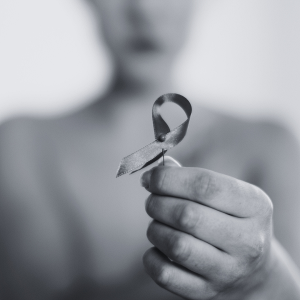 woman with a ribbon supporting survivors of hr positive Breast Cancer