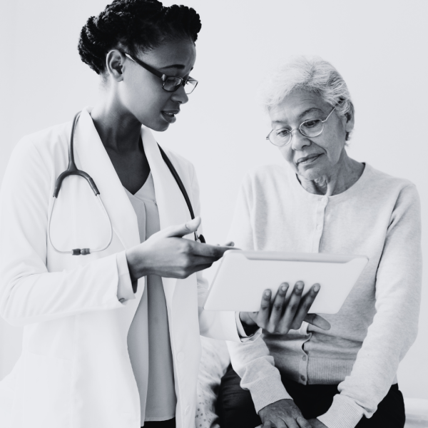 Doctor discussing healthy weight management with a patient as part of cancer risk reduction and prevention care.